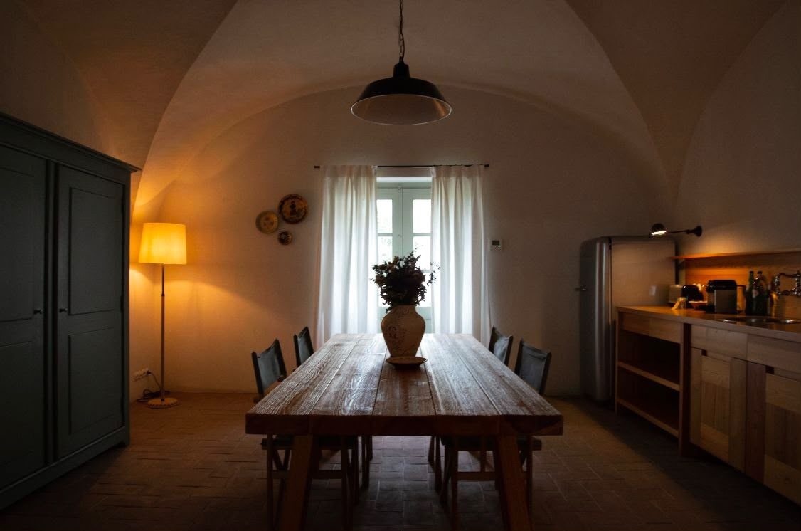 Warm dining room with table and lamp