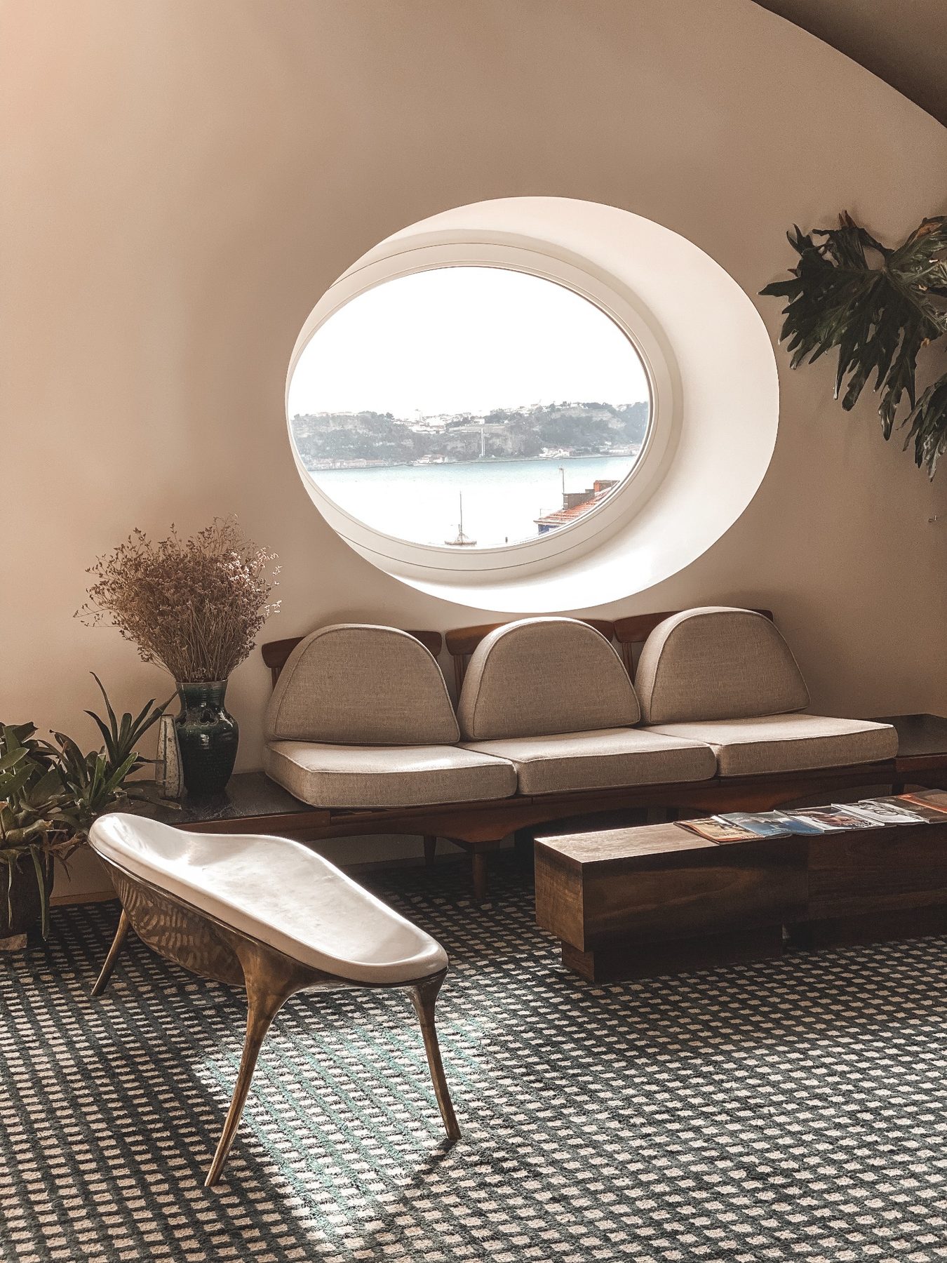 Lounge with round window and water view